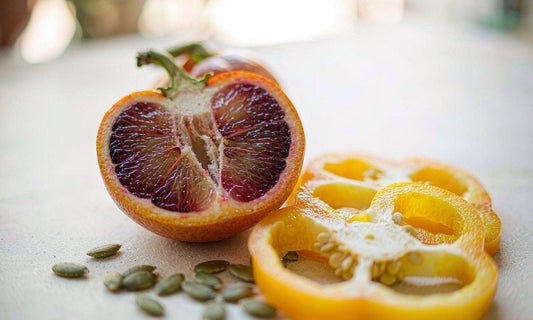 Macro of blood orange, yellow pepper and pumpkin seeds for vitamin C and zinc